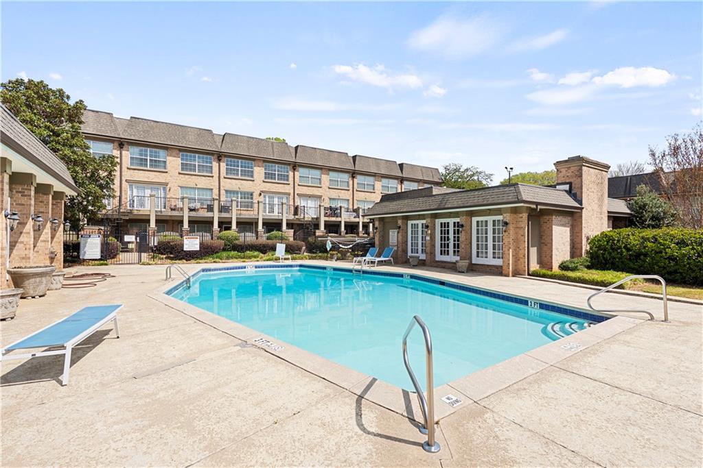 6980 Roswell Road, Unit K4 Atlanta, GA 30328 - Photo 7 of 31 a view of a swimming pool with a lounge chair