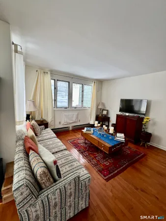 a bedroom with furniture and wooden floor