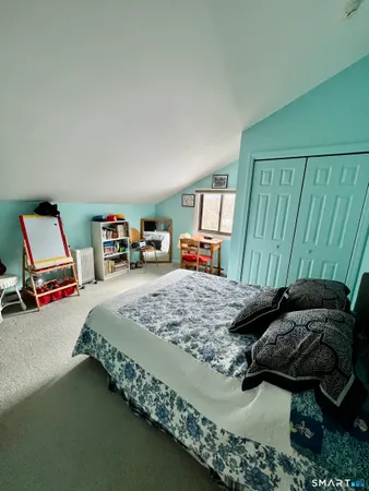 a bedroom with bed and a window