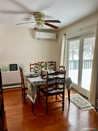 a view of a dining room with furniture wooden floor and chandelier