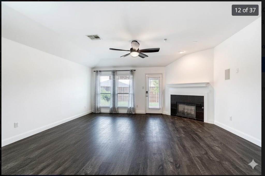 4020 Cherry Ridge Drive Frisco, TX 75033 - Photo 10 of 12 a view of an empty room with wooden floor fireplace and a window