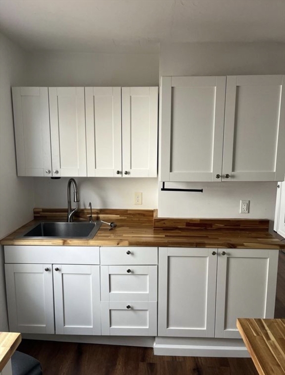 26 Edgeworth Street, Unit 1 Worcester, MA 01605 - Photo 7 of 13 a kitchen with granite countertop white cabinets and sink