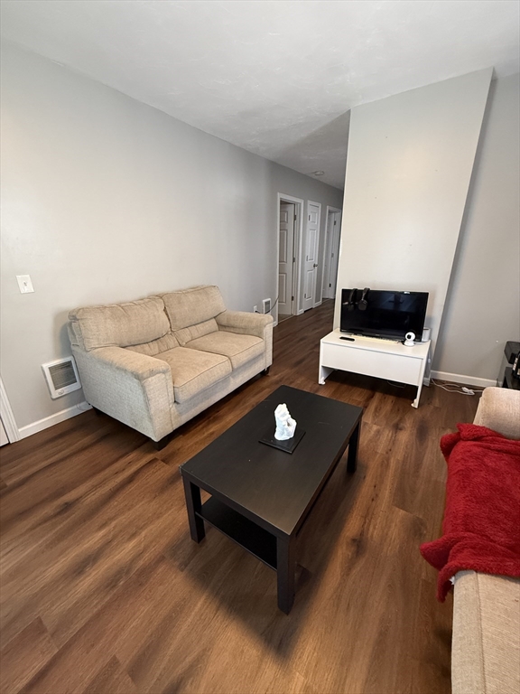 26 Edgeworth Street, Unit 1 Worcester, MA 01605 - Photo 8 of 13 a living room with furniture and wooden floor