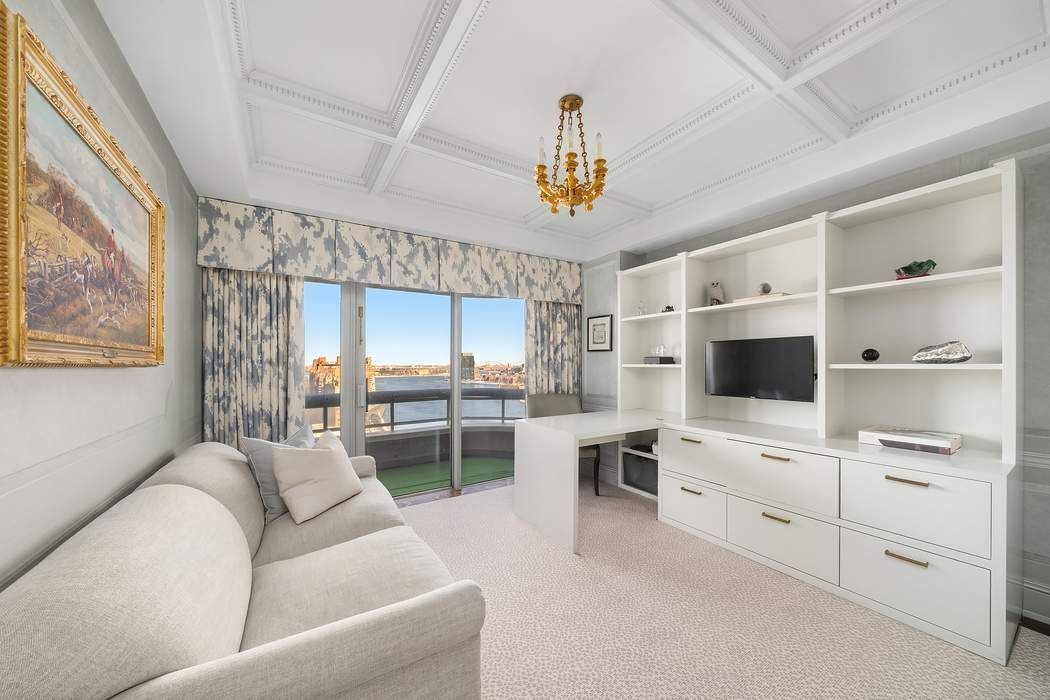 530 East 76th Street, Unit 22CDEG Manhattan, NY 10021 - Photo 20 of 31 a living room with furniture a flat screen tv and a window