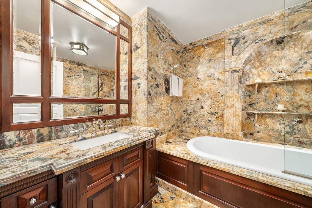 530 East 76th Street, Unit 22CDEG Manhattan, NY 10021 - Photo 23 of 31 a bathroom with a granite countertop sink and a large mirror
