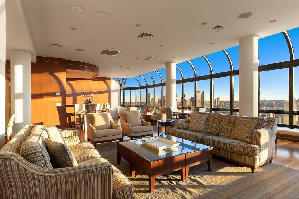 530 East 76th Street, Unit 22CDEG Manhattan, NY 10021 - Photo 26 of 31 a living room with furniture and a large window