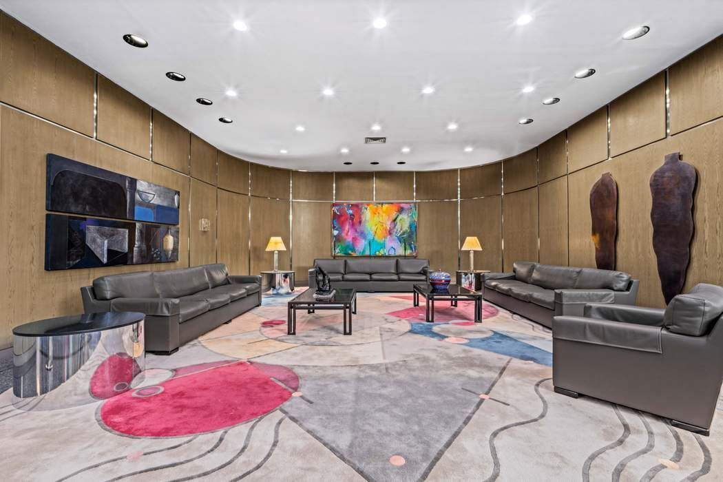 530 East 76th Street, Unit 22CDEG Manhattan, NY 10021 - Photo 28 of 31 a living room with furniture and a flat screen tv