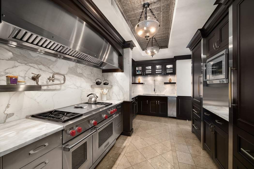 530 East 76th Street, Unit 22CDEG Manhattan, NY 10021 - Photo 7 of 31 a kitchen with stainless steel appliances granite countertop a stove and a refrigerator