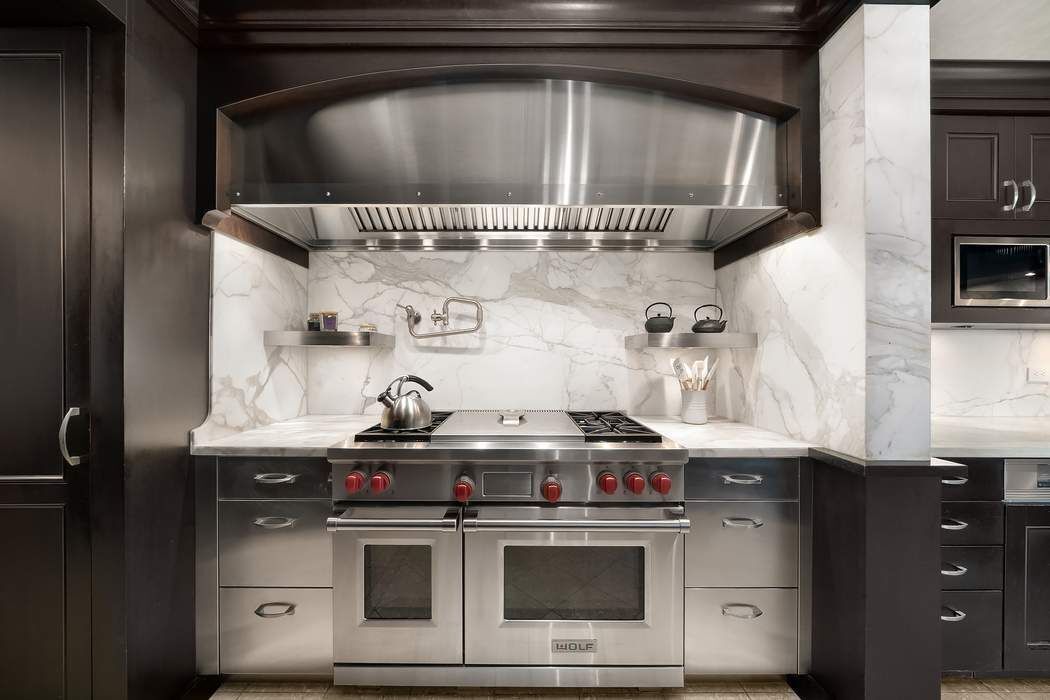530 East 76th Street, Unit 22CDEG Manhattan, NY 10021 - Photo 8 of 31 a stove top oven sitting inside of a kitchen