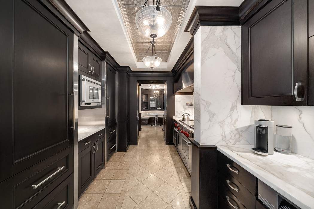 530 East 76th Street, Unit 22CDEG Manhattan, NY 10021 - Photo 9 of 31 a kitchen with stainless steel appliances granite countertop a sink stove and refrigerator