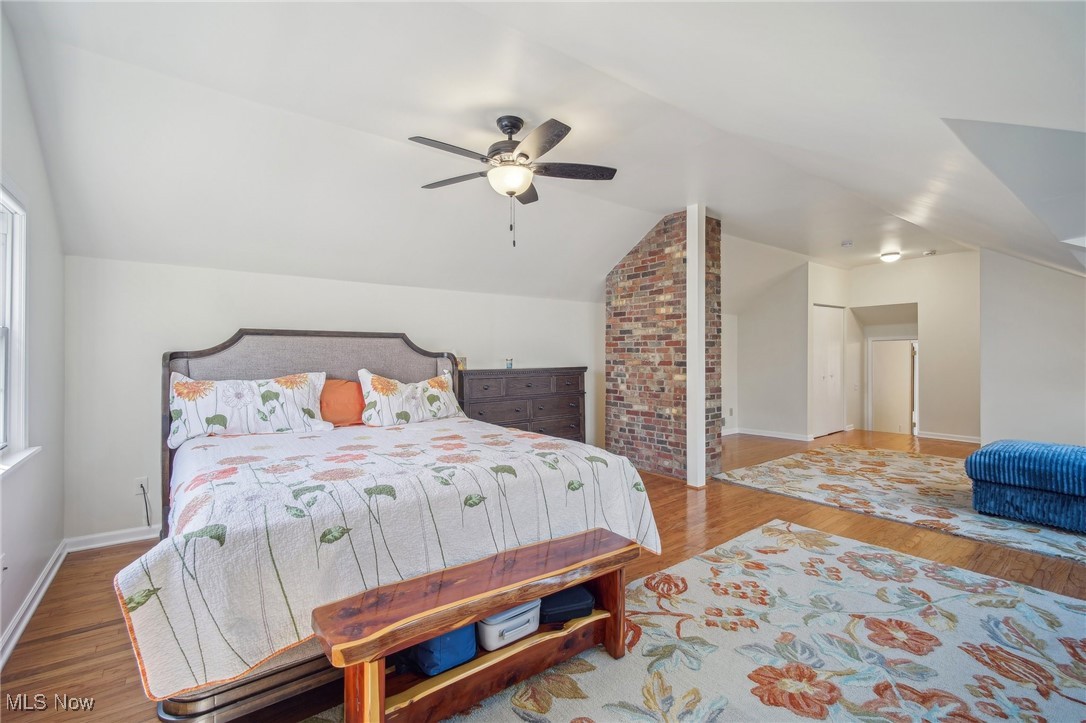 1445 Westover Road Cleveland, OH 44118 - Photo 27 of 47 Large primary bedroom with vaulted ceiling, wood floor, ceiling fan, and closets