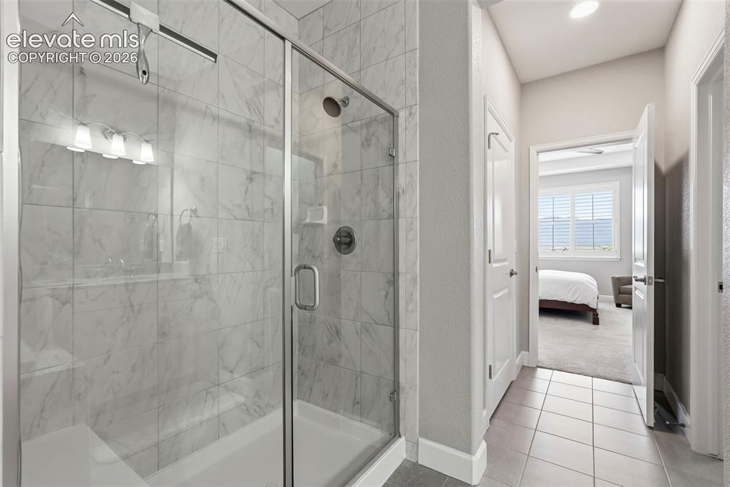 1394 Promontory Bluff View Colorado Springs, CO 80921 - Photo 30 of 47 a en suite bathroom with a glass door shower