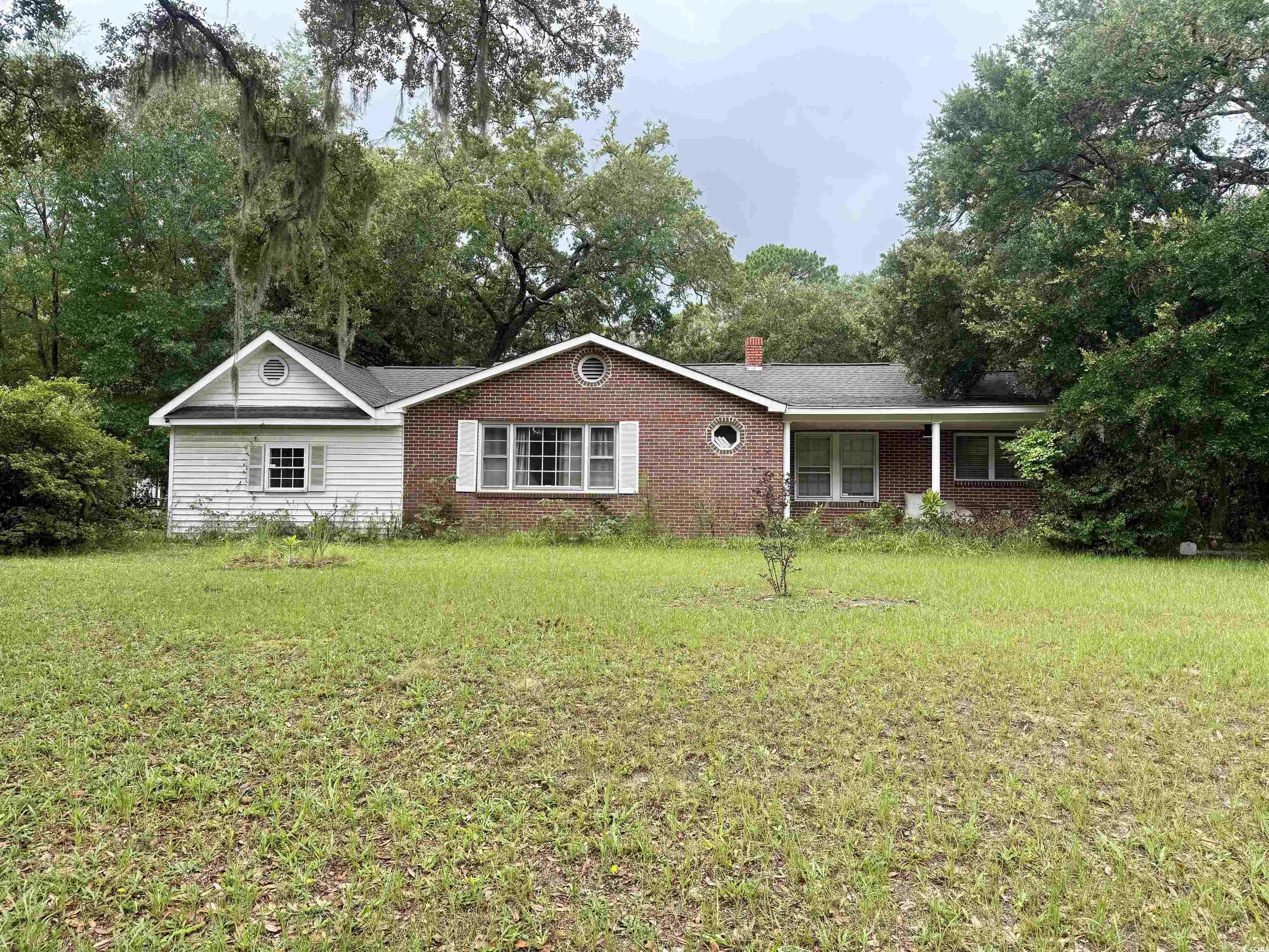 Ranch-style house featuring brick siding, a front