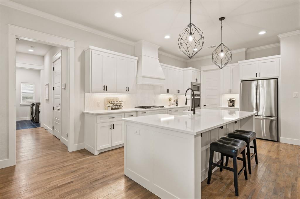 200 Clayton Crossing Springtown, TX 76082 - Photo 10 of 40 a kitchen with a refrigerator a sink and cabinets