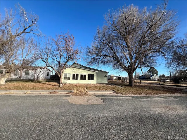 a view of road with large trees