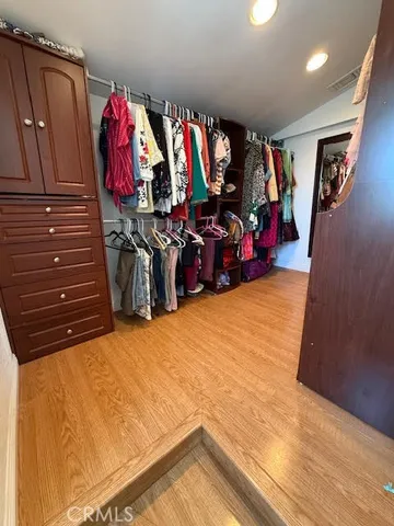 a view of walk in closet with clothes