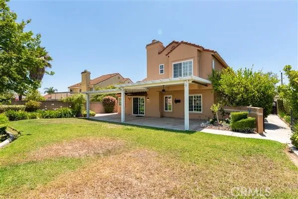 a view of a house with a yard and sitting area