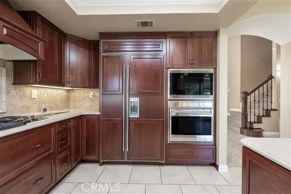 a kitchen with stainless steel appliances granite countertop a refrigerator and a stove