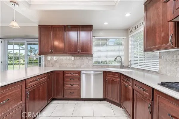 a kitchen with stainless steel appliances granite countertop wooden cabinets a sink and dishwasher