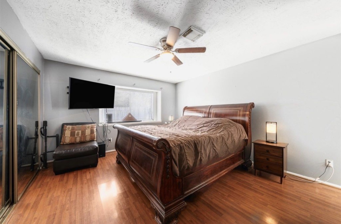 17314 Edenbridge Court Spring, TX 77379 - Photo 18 of 33 a spacious bedroom with a bed and a flat screen tv