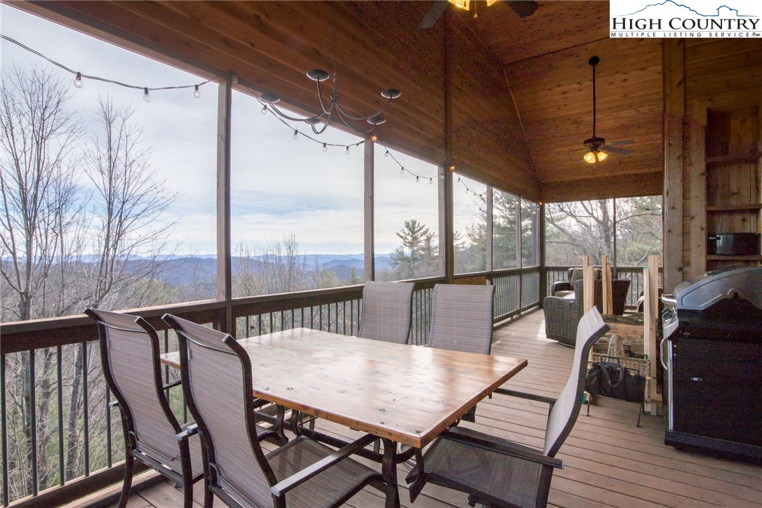 a view of a patio with a table chairs and wooden floor