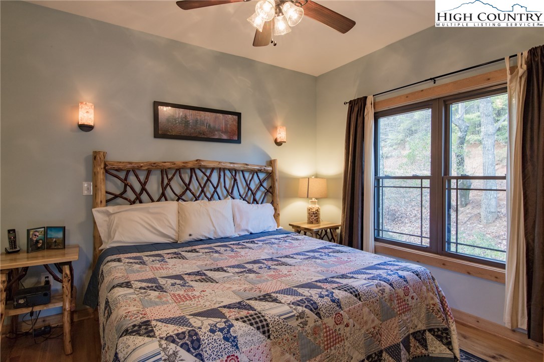4091 Staghorn Road Purlear, NC 28665 - Photo 20 of 47 a bedroom with a large bed and a large window