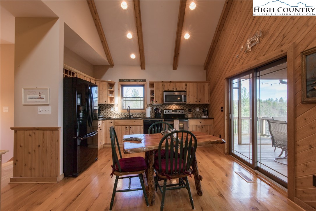 4091 Staghorn Road Purlear, NC 28665 - Photo 6 of 47 a dining room with furniture and wooden floor