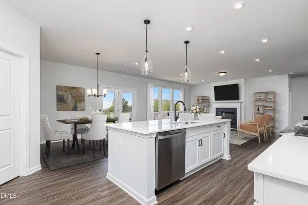 a kitchen with stainless steel appliances kitchen island granite countertop a sink a stove and cabinets