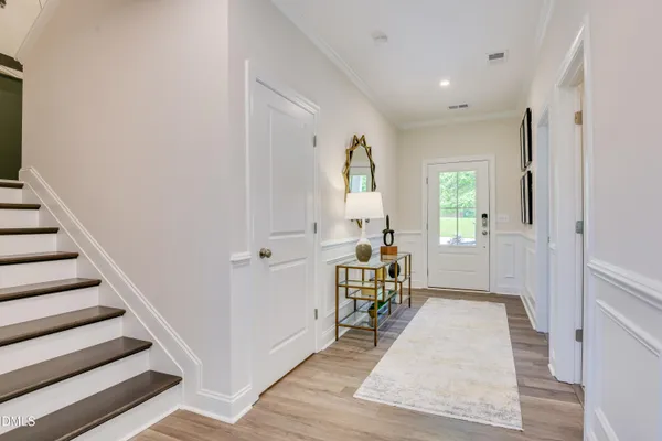 a view of a livingroom with wooden floor and furniture