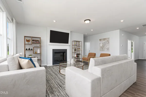 a living room with furniture a fireplace and a flat screen tv