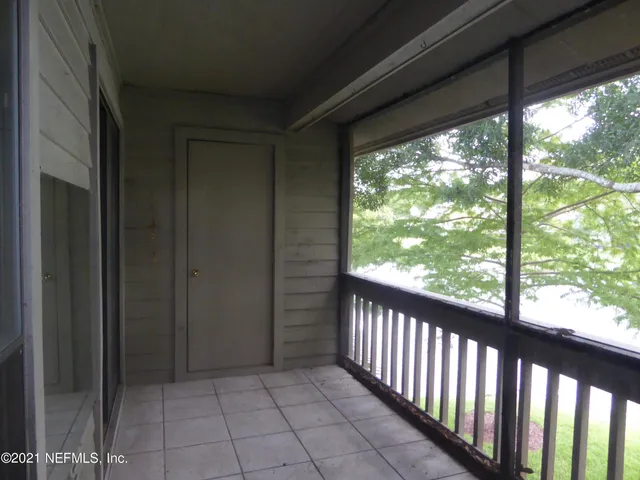 a view of a glass door and the balcony