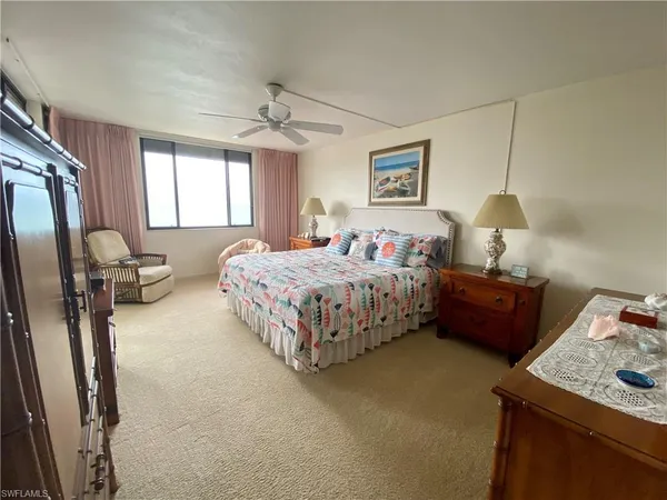 a bedroom with a bed and a dresser in it