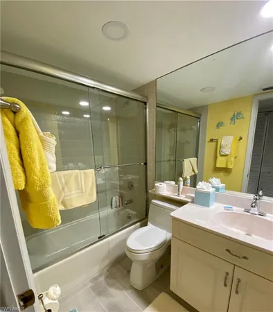 a bathroom with a double vanity sink toilet and shower