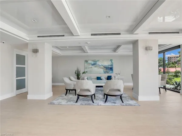 a living room with lots of furniture and a large window