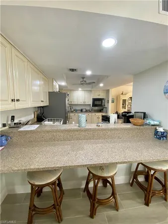 a kitchen with a table chairs stove and kitchen island