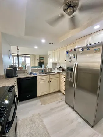 a kitchen with cabinets and stainless steel appliances