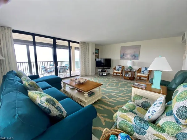 a living room with furniture and a large window
