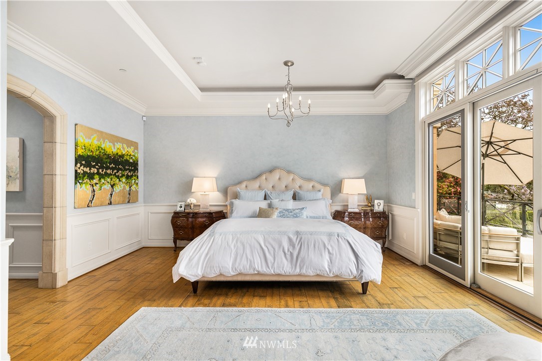8715 Midland Road Medina, WA 98039 - Photo 14 of 31 a spacious bedroom with a bed and a chandelier