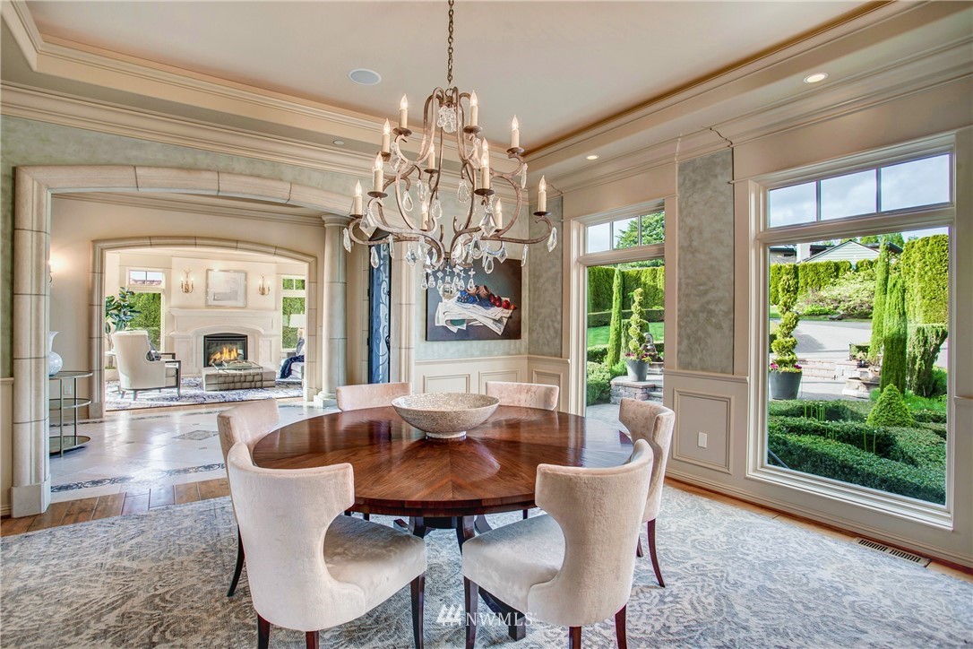 8715 Midland Road Medina, WA 98039 - Photo 5 of 31 a dining room with furniture a chandelier and wooden floor