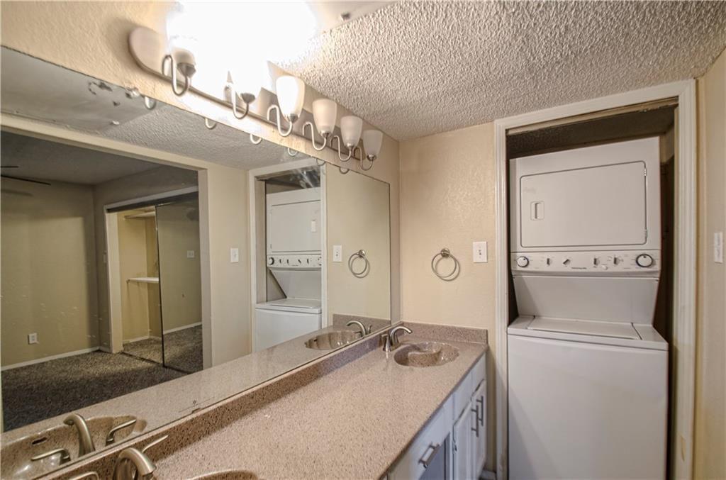 9835 Walnut Street, Unit 202 Dallas, TX 75243 - Photo 16 of 19 Double vanity with integrated sinks and a speckled countertop