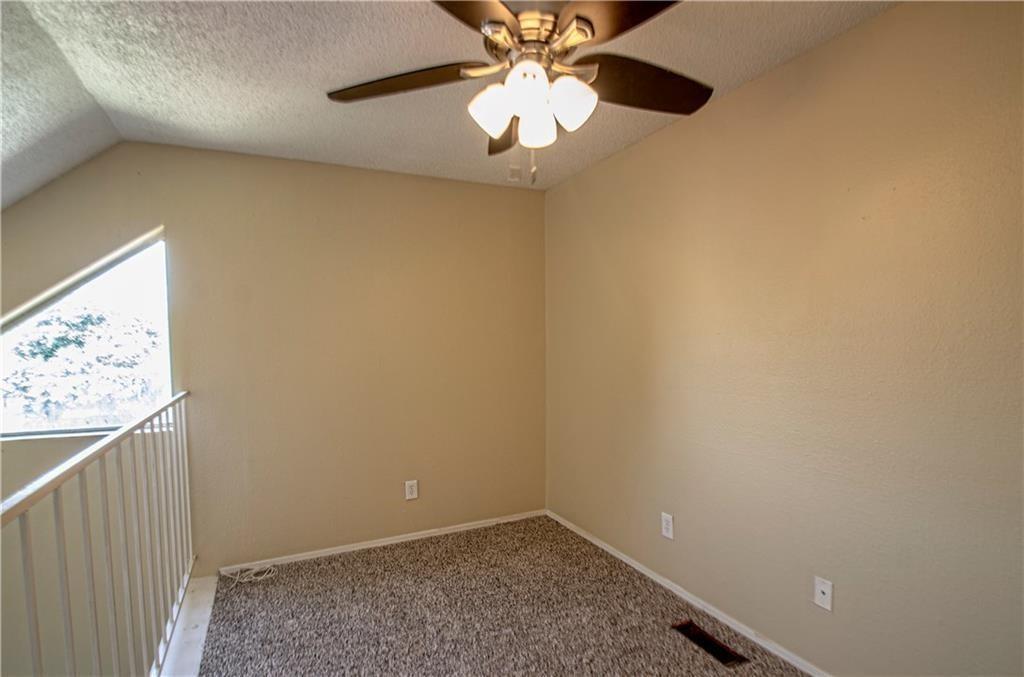 9835 Walnut Street, Unit 202 Dallas, TX 75243 - Photo 7 of 19 Carpeted interior space featuring a sloped ceiling and a ceiling fan with integrated lighting