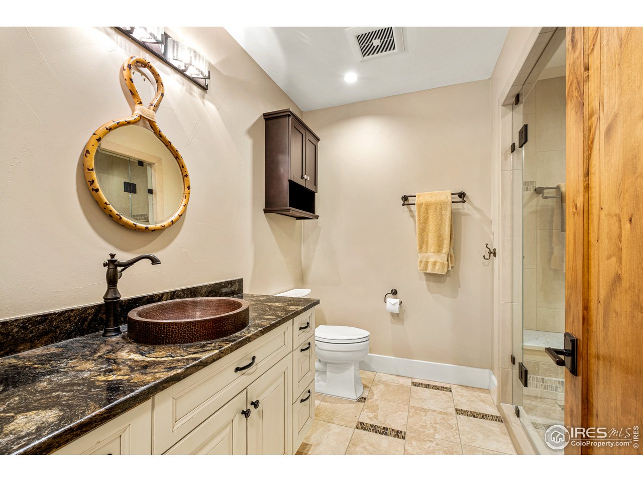 901 Pearl Street, Unit 202 Boulder, CO 80302 - Photo 29 of 35 a bathroom with a granite countertop sink a toilet and a mirror