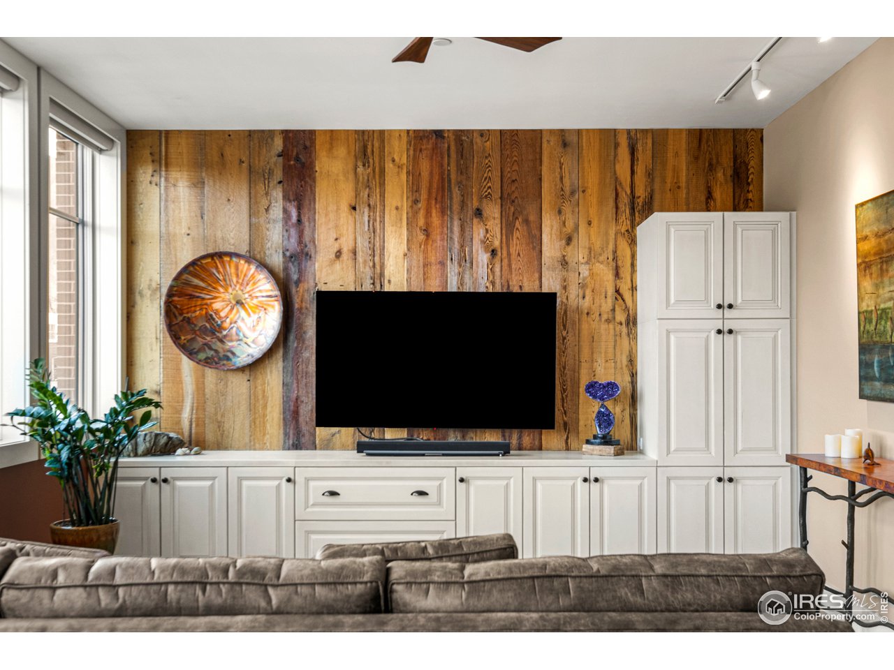 901 Pearl Street, Unit 202 Boulder, CO 80302 - Photo 7 of 35 a living room with a flat screen tv and a large tree