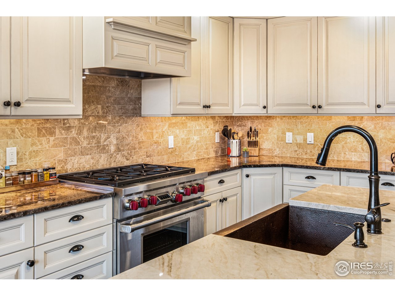 901 Pearl Street, Unit 202 Boulder, CO 80302 - Photo 10 of 35 a kitchen with granite countertop a stove a sink and cabinets