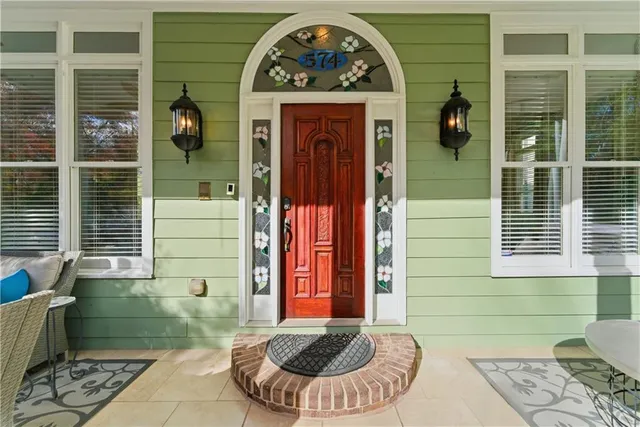 a living room with stainless steel appliances kitchen island granite countertop furniture a rug a kitchen and a fireplace