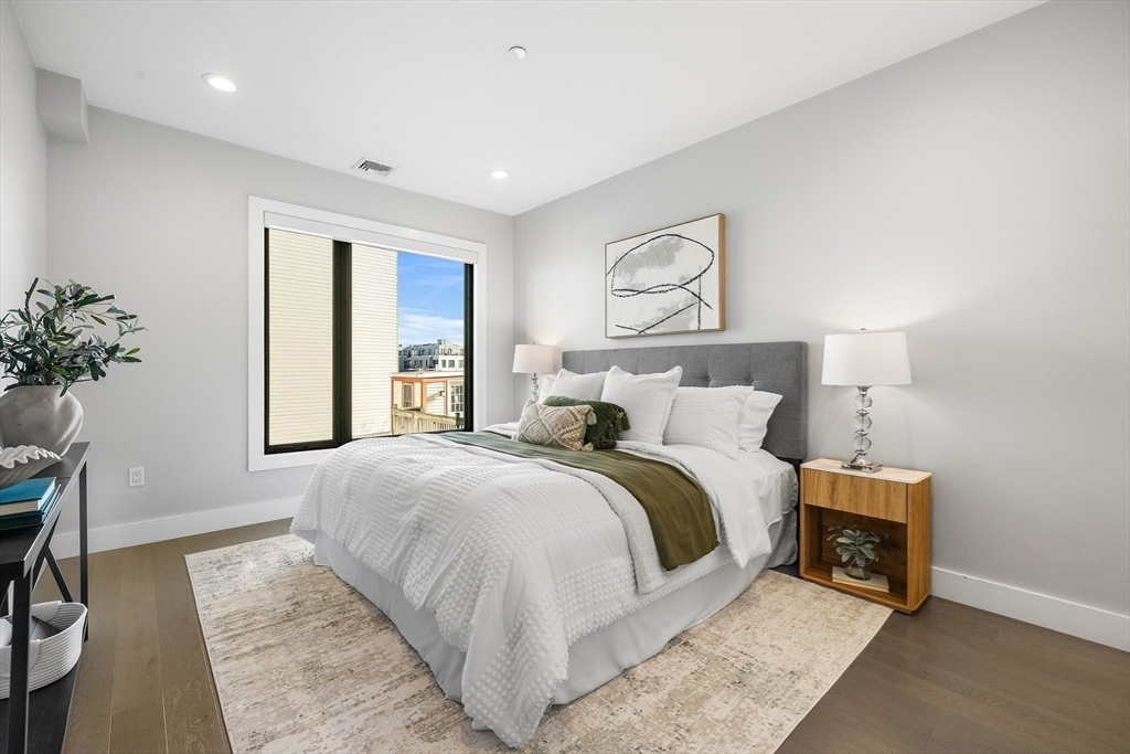 39 A Street, Unit 19 Boston, MA 02127 - Photo 11 of 24 a bedroom with a large bed and a window