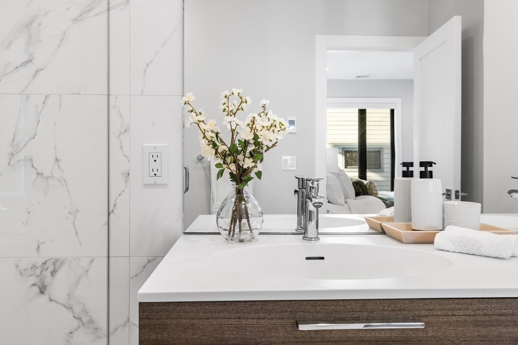 39 A Street, Unit 19 Boston, MA 02127 - Photo 15 of 24 a bathroom with a sink a vanity and a mirror