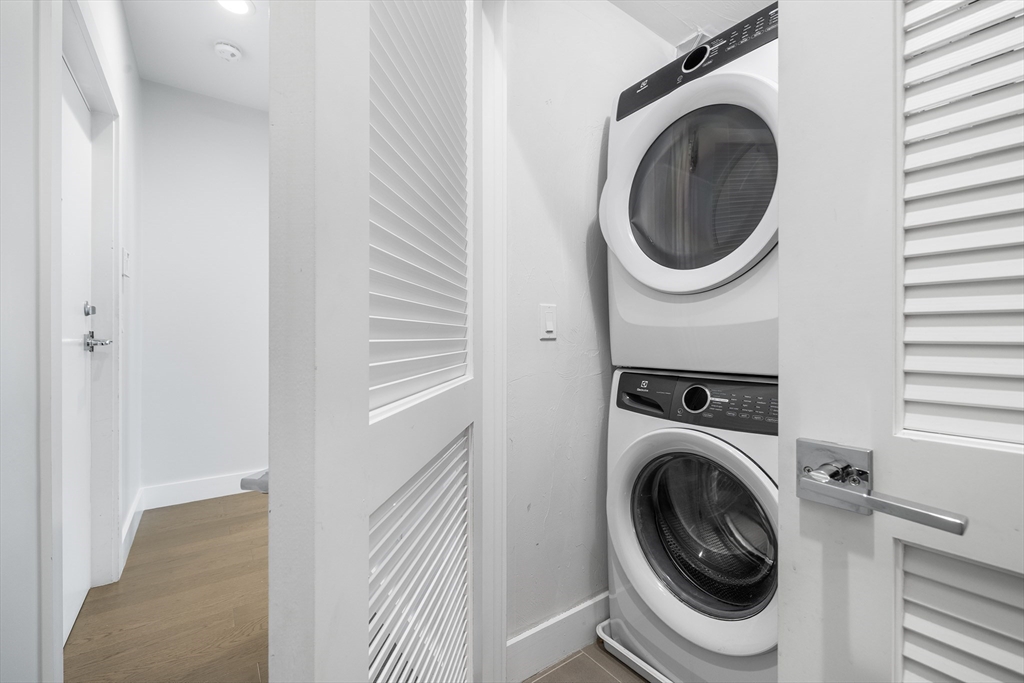 39 A Street, Unit 19 Boston, MA 02127 - Photo 17 of 24 a view of a hallway with washer and dryer