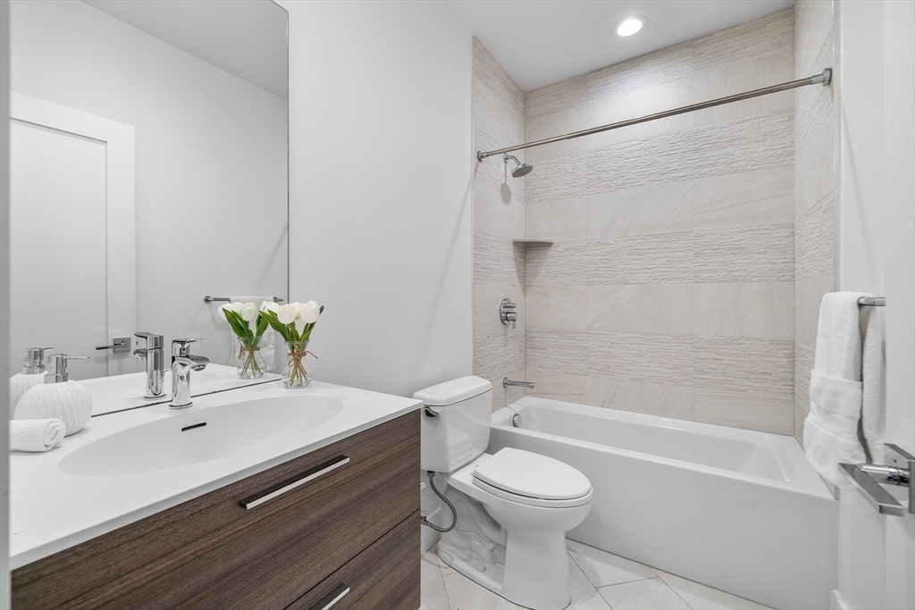 39 A Street, Unit 19 Boston, MA 02127 - Photo 20 of 24 a bathroom with a sink a toilet and a bathtub