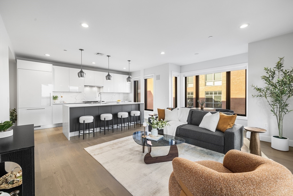 39 A Street, Unit 19 Boston, MA 02127 - Photo 8 of 24 a living room with furniture and a large window